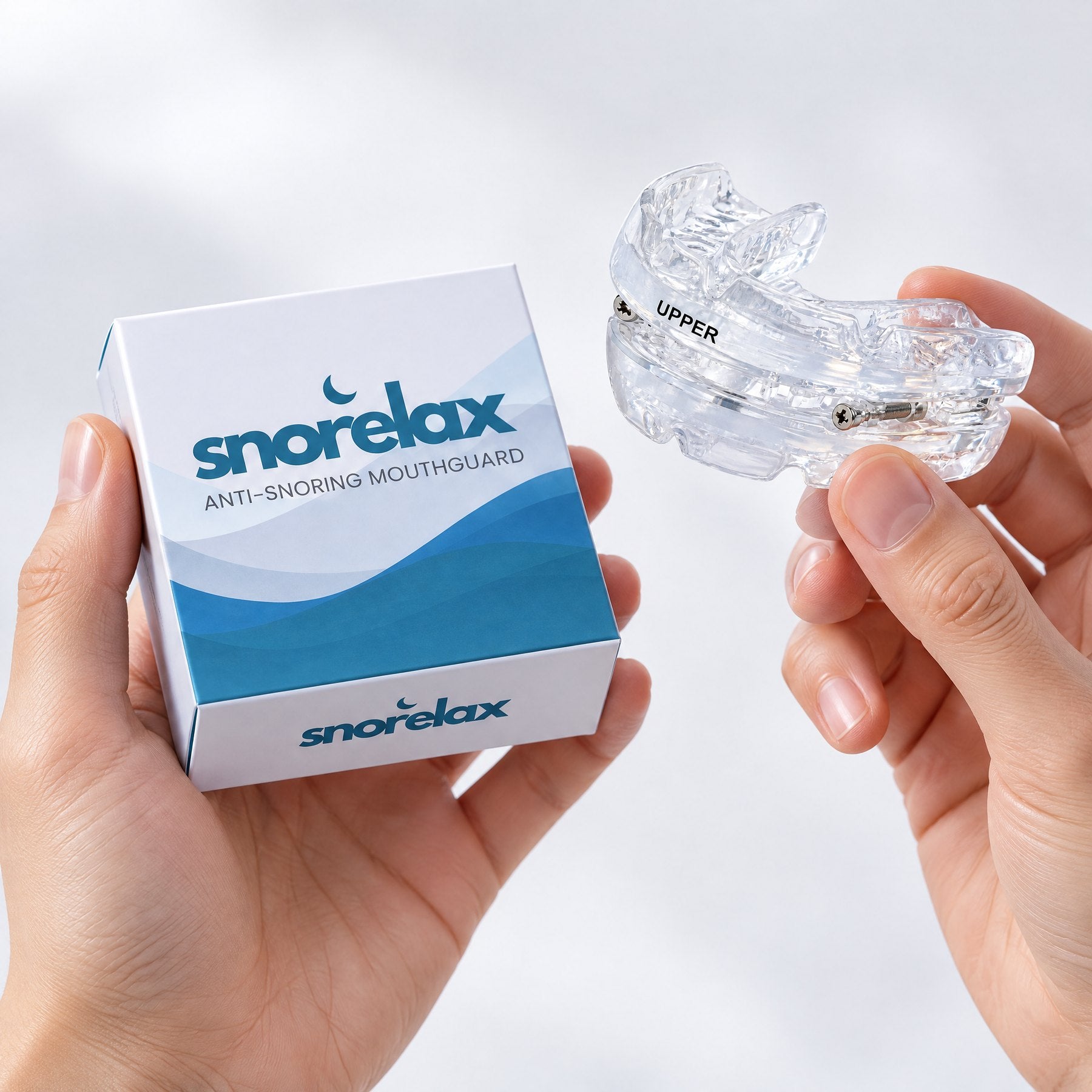 SnoreLax Pro anti-snoring mouthguard in hand with packaging